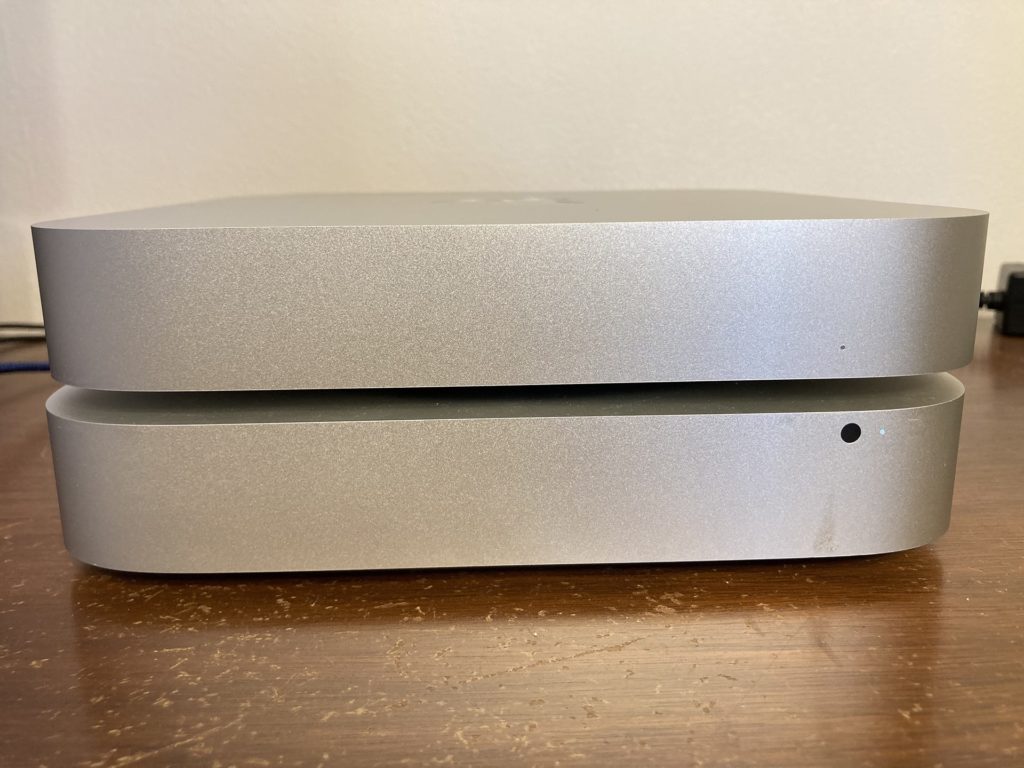 Comparing the front of the 2022 M2 Mac mini stacked on top of a Late 2014 Mac mini