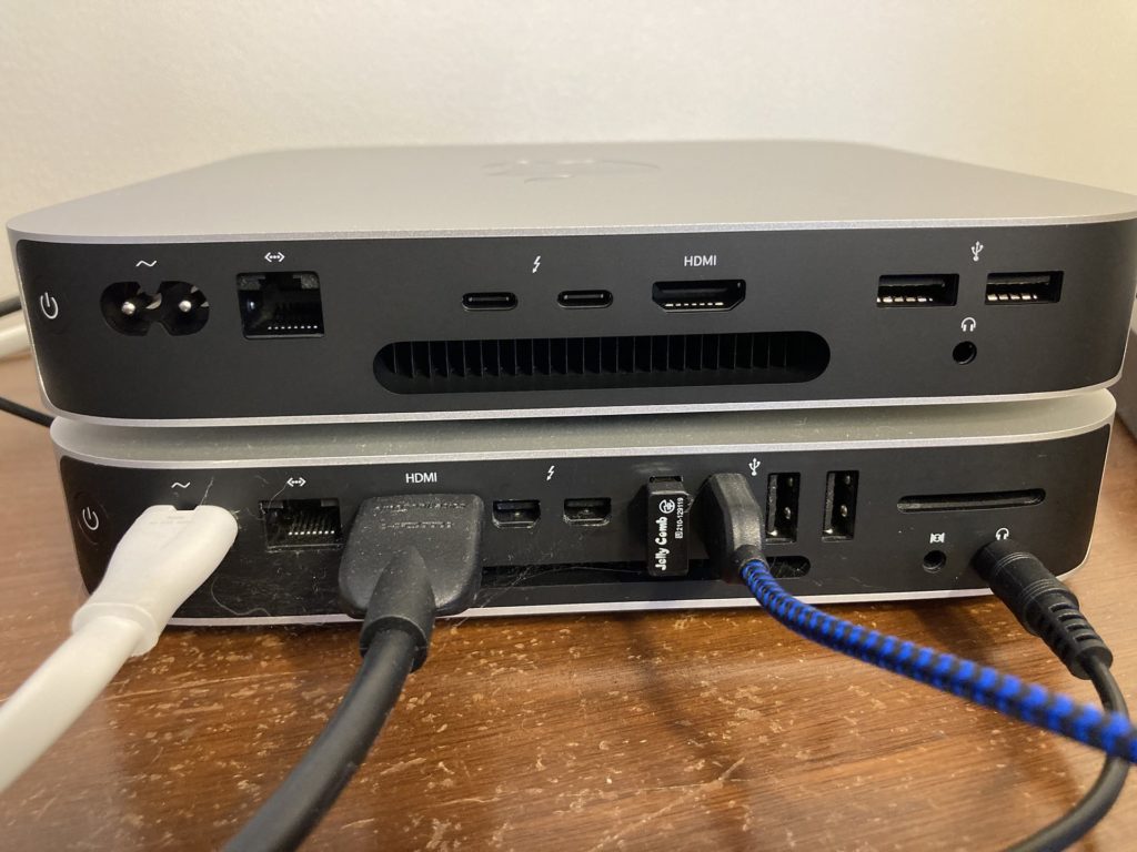 Comparing the back ports of the 2022 M2 Mac mini stacked on top of a Late 2014 Mac mini