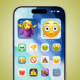 An iPhone with different emojis sitting over every icon and widget on the home screen. Emojis including the skull, thumbs down, vomit face, pile of poo, etc.
